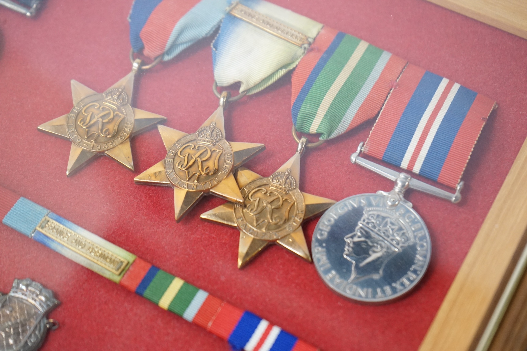 WWII Naval DSM group - framed, to Walter Charles King, comprising a replacement Distinguished Service Medal, the 1939-1945 Star, the Atlantic Star with clasp for France and Germany, the Pacific Star, and the 1939-1945 Me
